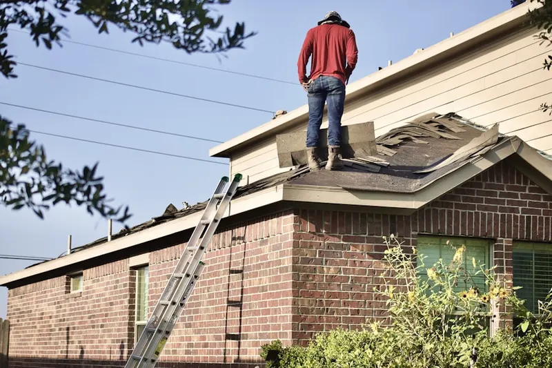 Professional roofer working on a residential roof in University Neighborhood